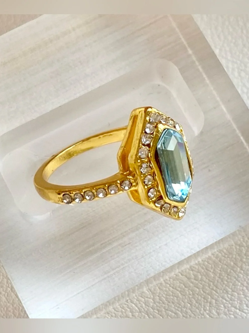 Gold Ring with Blue Gemstone and Clear Accent Stones